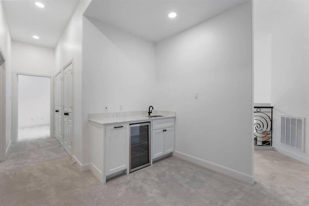 The game room also offers a newly remodeled bar area with quartz countertops, cabinetry, a wet sink, and a beverage refrigerator—perfect for entertaining.