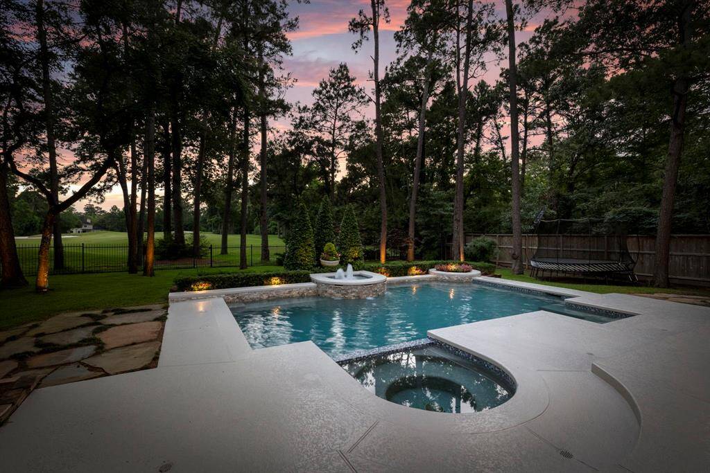 Enjoy the ultimate in outdoor living with a stunning resort-style pool and generous green space right in your own backyard. Perfect for relaxing, entertaining, or making lasting family memories, the beautifully designed pool features elegant stonework, a soothing water feature, and ample deck space for lounging.