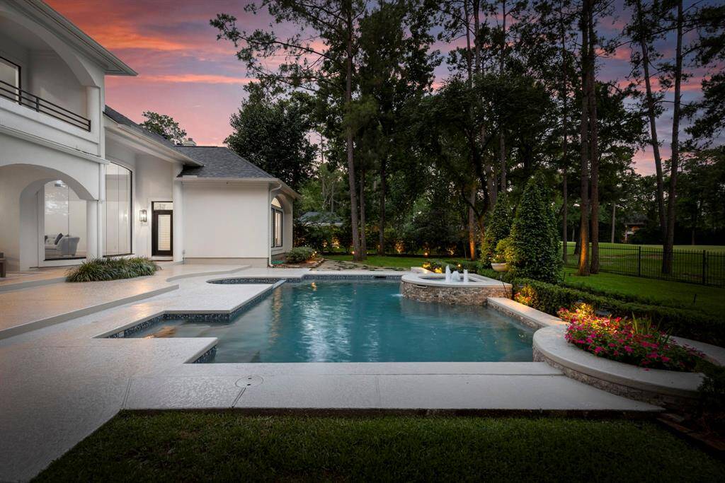 The lush green lawn offers plenty of room for play, pets, or gardening, while mature landscaping provides a sense of privacy and tranquility.