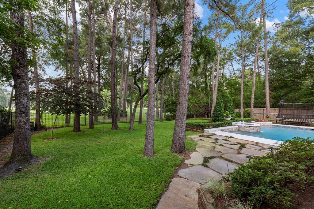 There's plenty of green space for play or relaxation, along with a new side fence offering enhanced privacy and a scenic view of the golf course.