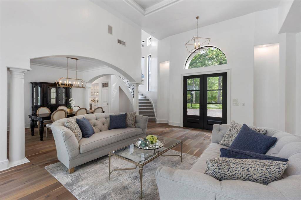 This alternative view of the living space highlights the thoughtfully designed architectural details found throughout the home including custom knotty alder wood front doors from Castle Doors.