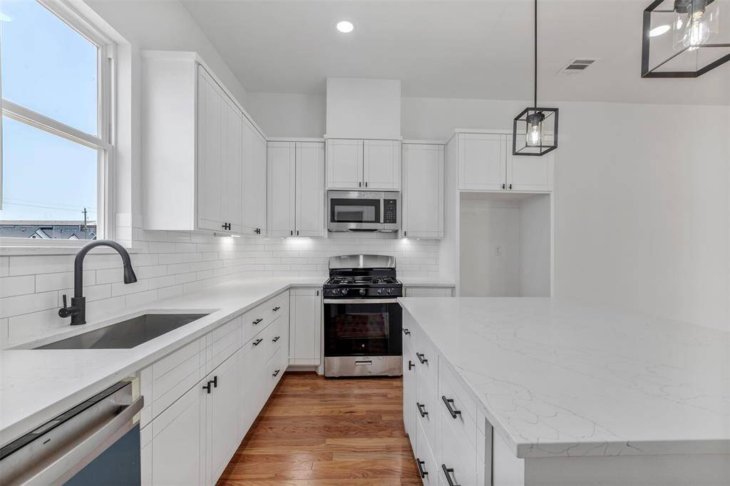 Another close-up view of the kitchen, highlighting the efficient layout of the appliances and the details of the cabinetry for a polished, functional space.