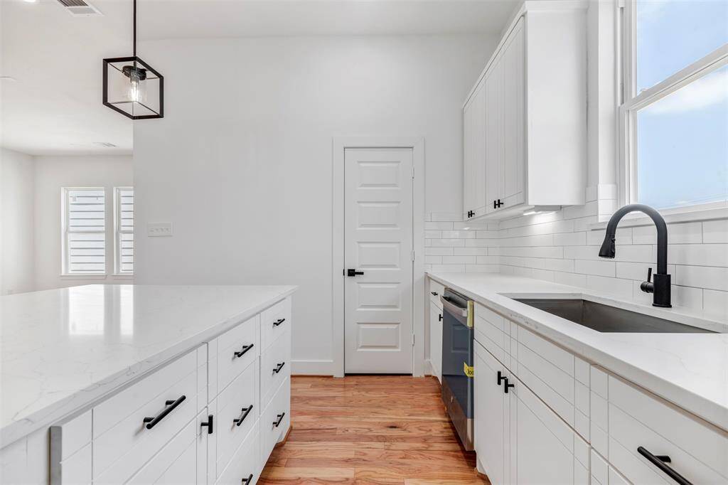 Take a closer look at the kitchen, where the pantry door is neatly tucked away, offering convenient storage for all your essentials.