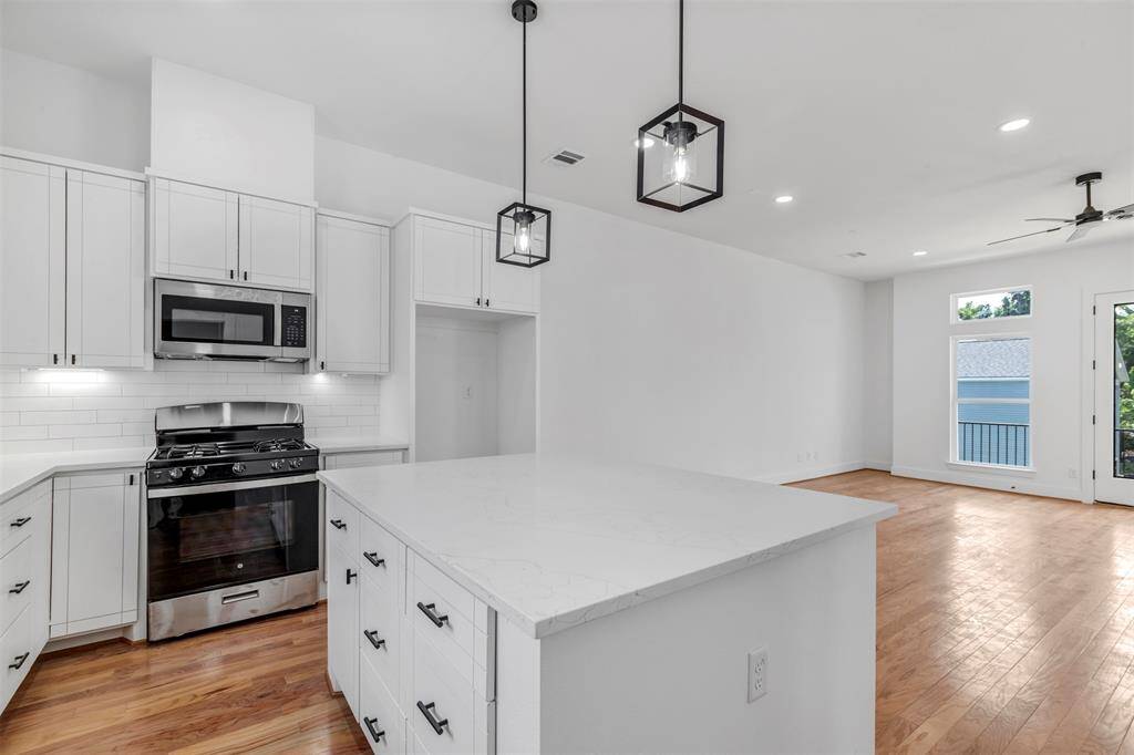 From this vantage point in the kitchen, enjoy a seamless view of the living room and balcony, making cooking a breeze with a beautiful backdrop.