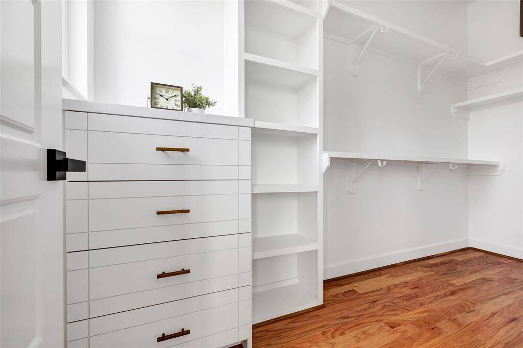 Step inside this spacious walk-in closet, offering plenty of room to organize and store all of your personal effects with ease. (Model unit at 1234 E 23rd St. Design and finishes may vary)