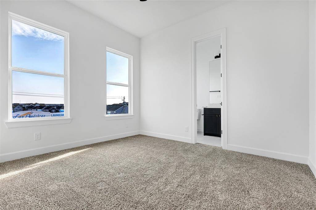 Transform this versatile secondary bedroom into your ideal space! It already features a convenient tub and shower combo, offering endless possibilities. (Model unit at 1234 E 23rd St. Design and finishes may vary)