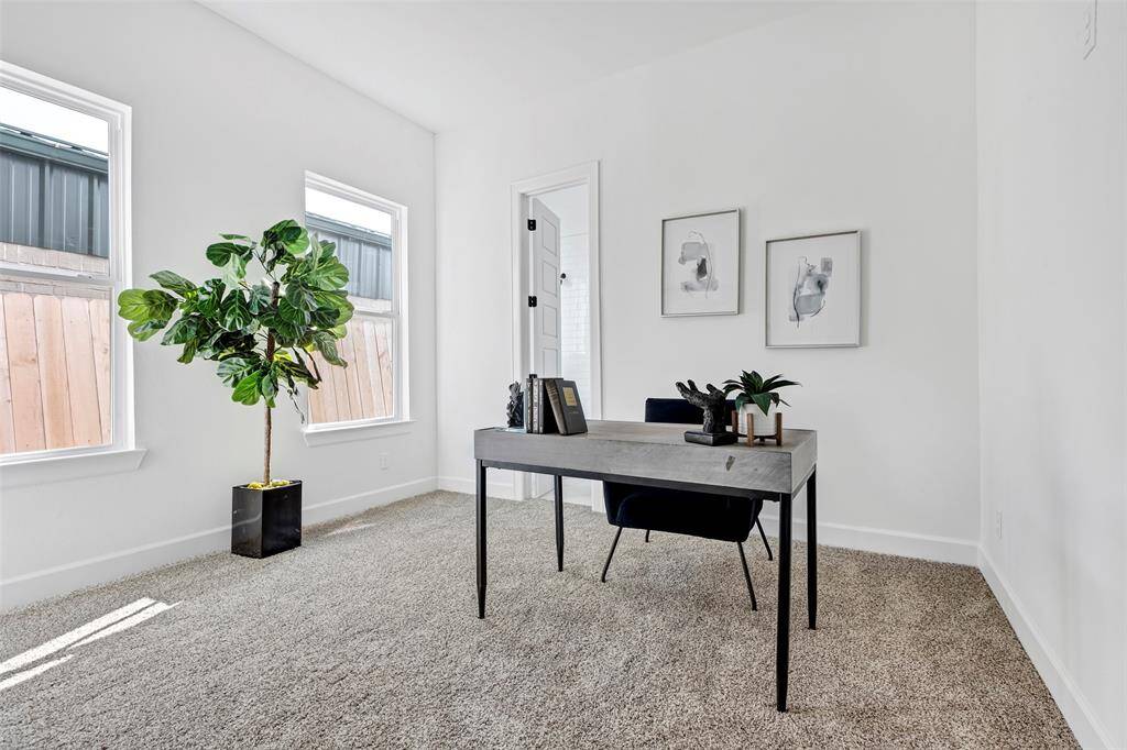 Endless possibilities await in this flexible space! Carpeted for comfort and bathed in natural light, perfect for a home office, playroom, or cozy lounge. (Model unit at 1234 E 23rd St. Design and finishes may vary)