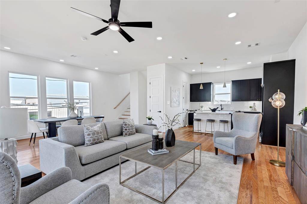 Enjoy seamless living with this open-concept living room, effortlessly flowing into the dining area and kitchen for a spacious, connected feel. (Model unit at 1234 E 23rd St. Design and finishes may vary)