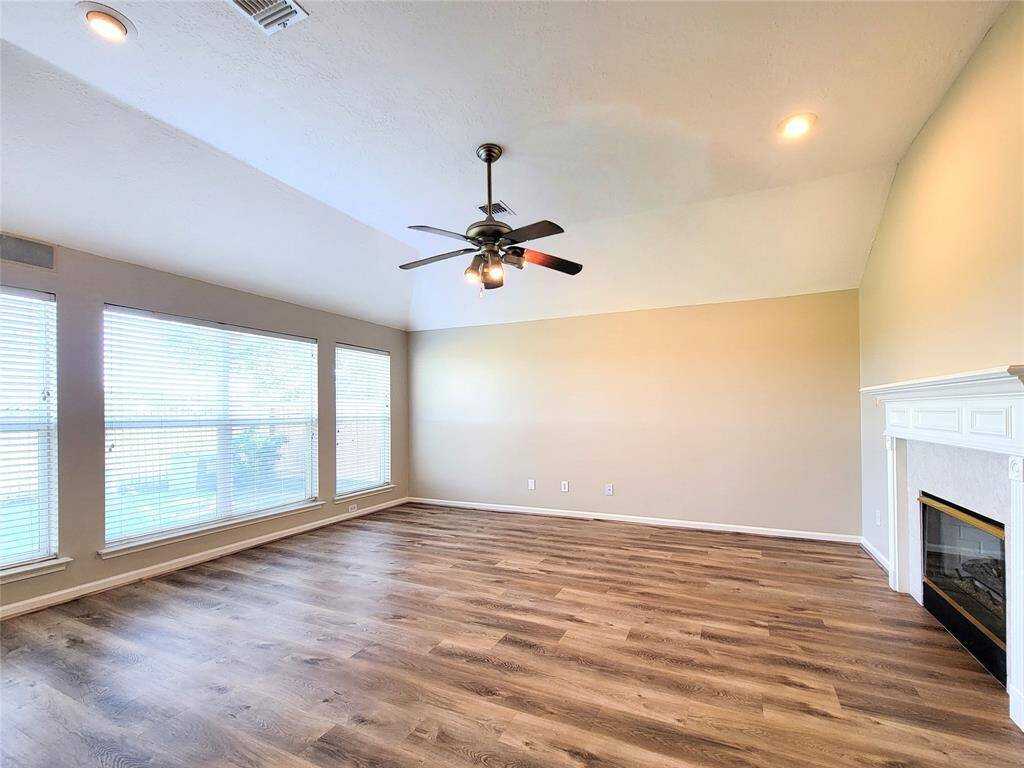 Huge Family room with fireplace & laminate flooring.