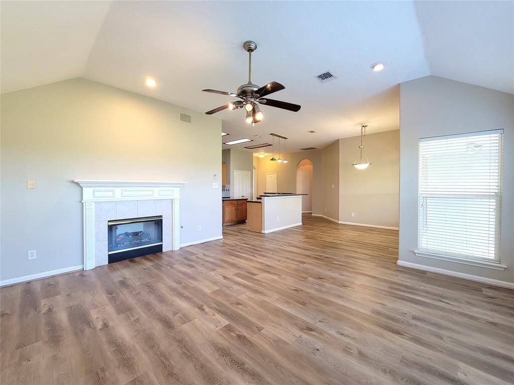 Another view of same room.  Gas log fireplace & remote-control ceiling fan.
