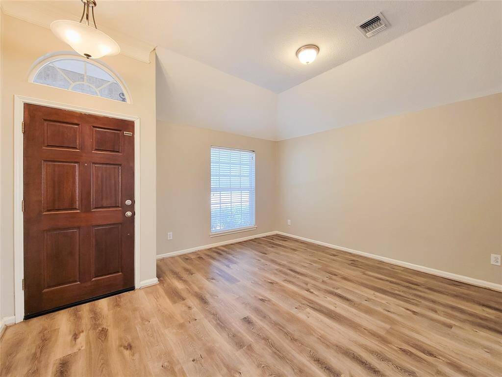 Entry & Formal Living Room. Recently updated with laminated Floor throughout the home.
