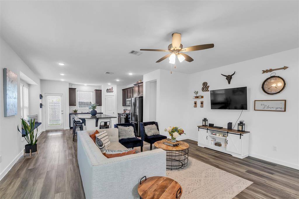 The living area is conveniently located just off the kitchen, creating a seamless flow that's perfect for entertaining guests or enjoying everyday family time.