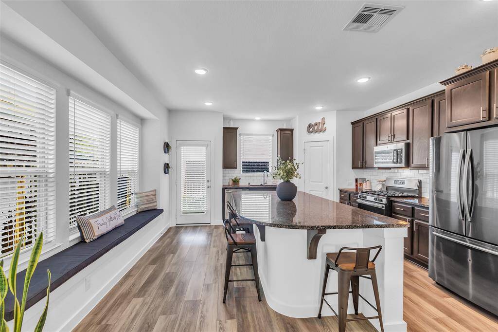 The large center island features a breakfast bar, great for morning coffee and casual dining.