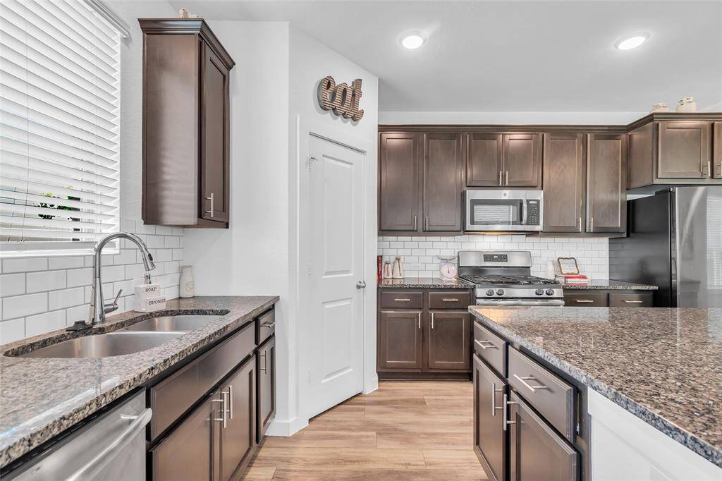 The kitchen also has lots of natural light and overlooks the backyard.