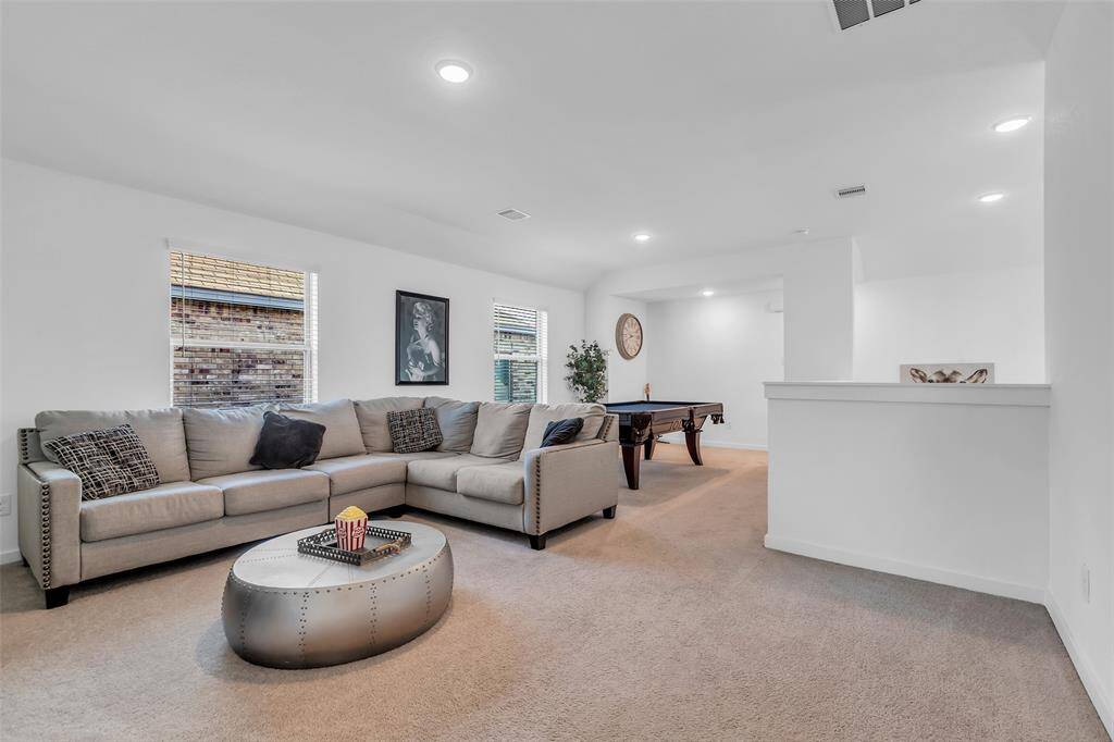 With plenty of room for a large sectional or game tables, it’s the perfect space to unwind, watch movies, or enjoy game nights with friends and family.
