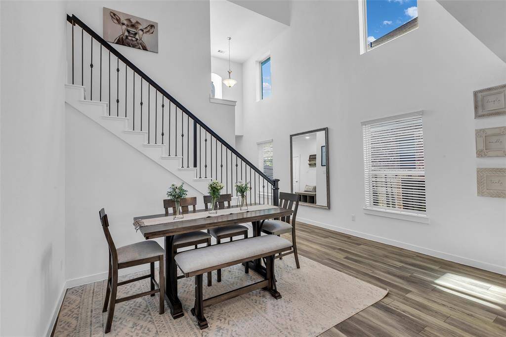 Soaring ceilings and an abundance of windows fill the home with natural light, creating a bright and airy atmosphere throughout.