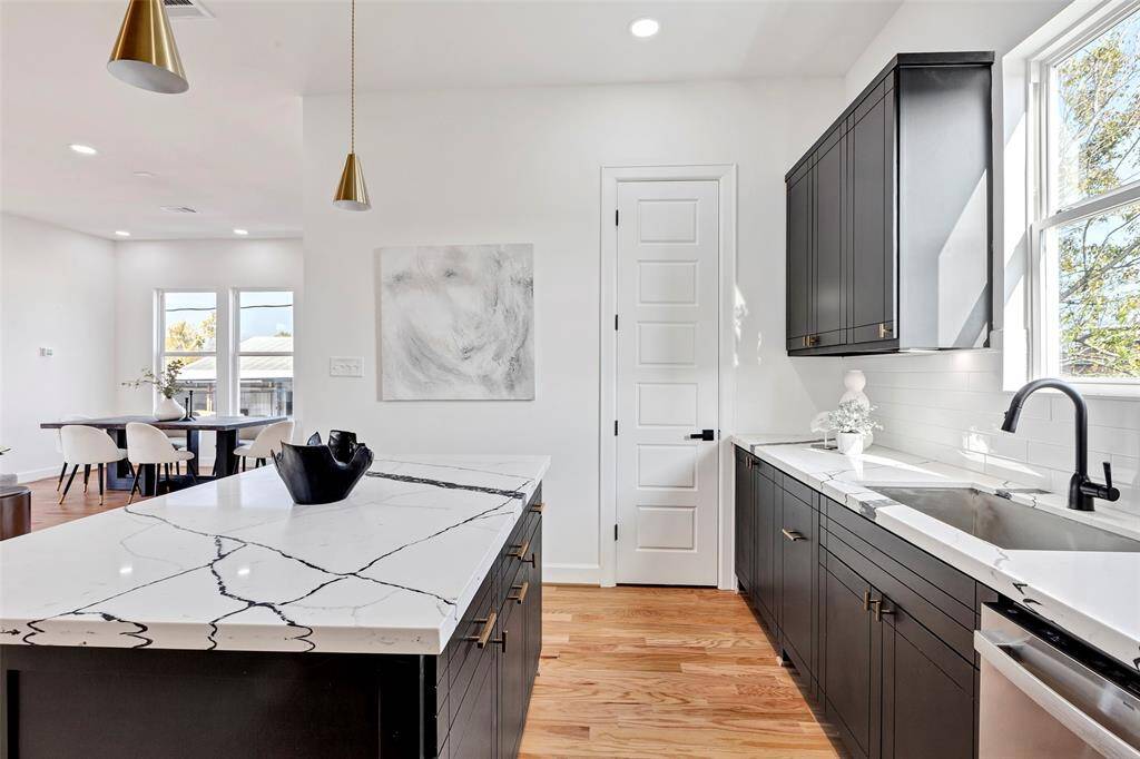 Take a closer look at the kitchen, where the pantry door is neatly tucked away, offering convenient storage for all your essentials.