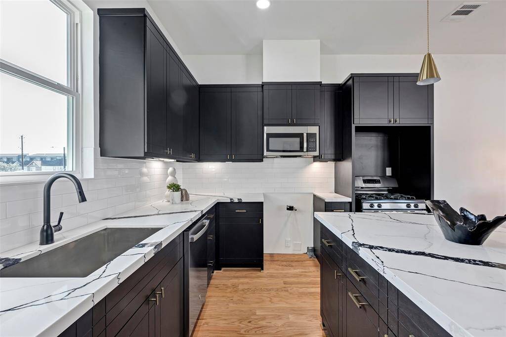Another close-up view of the kitchen, highlighting the efficient layout of the appliances and the details of the cabinetry for a polished, functional space.