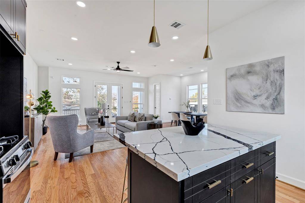 From this vantage point in the kitchen, enjoy a seamless view of the living room and balcony, making cooking a breeze with a beautiful backdrop.