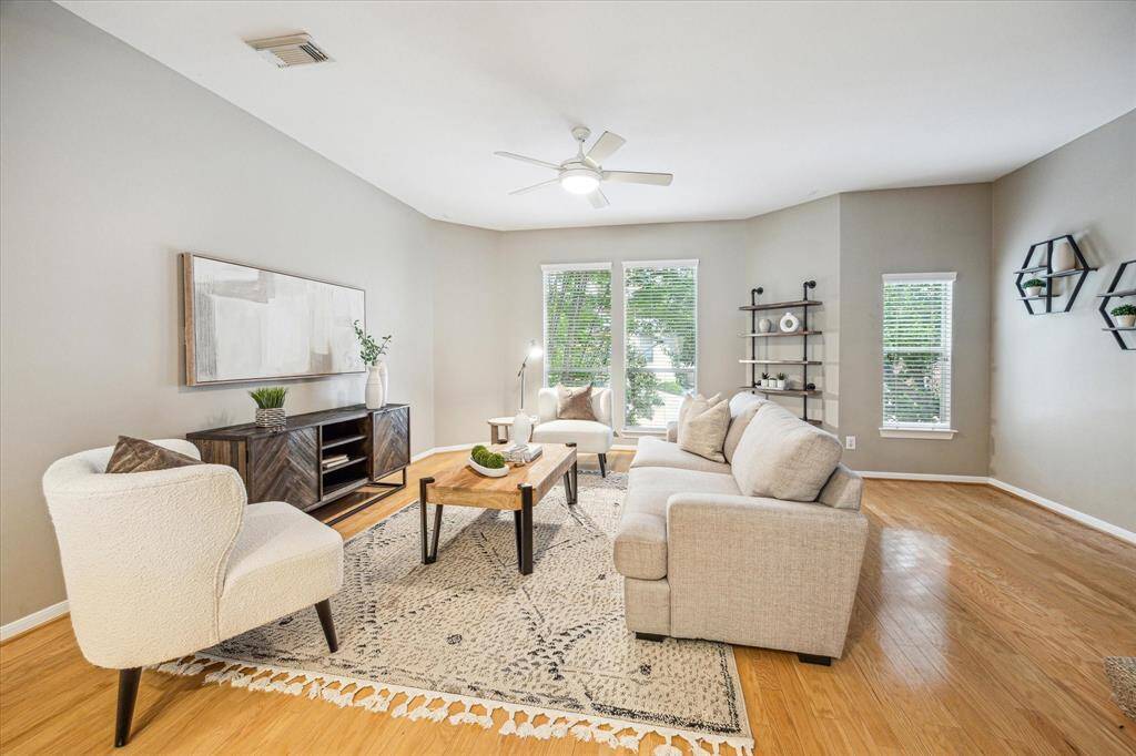 This second-floor living area offers a warm and welcoming space to relax or entertain, with beautiful wood flooring, soft neutral tones, and a spacious layout that makes it easy to gather with friends and family.