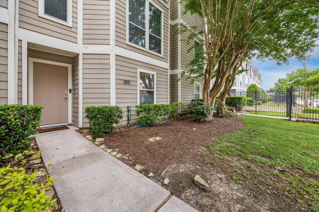 Tucked beneath a canopy of mature trees, this charming three-story home offers inviting curb appeal with fresh exterior paint, manicured landscaping, and a welcoming entry that sets the tone for the stylish spaces inside.