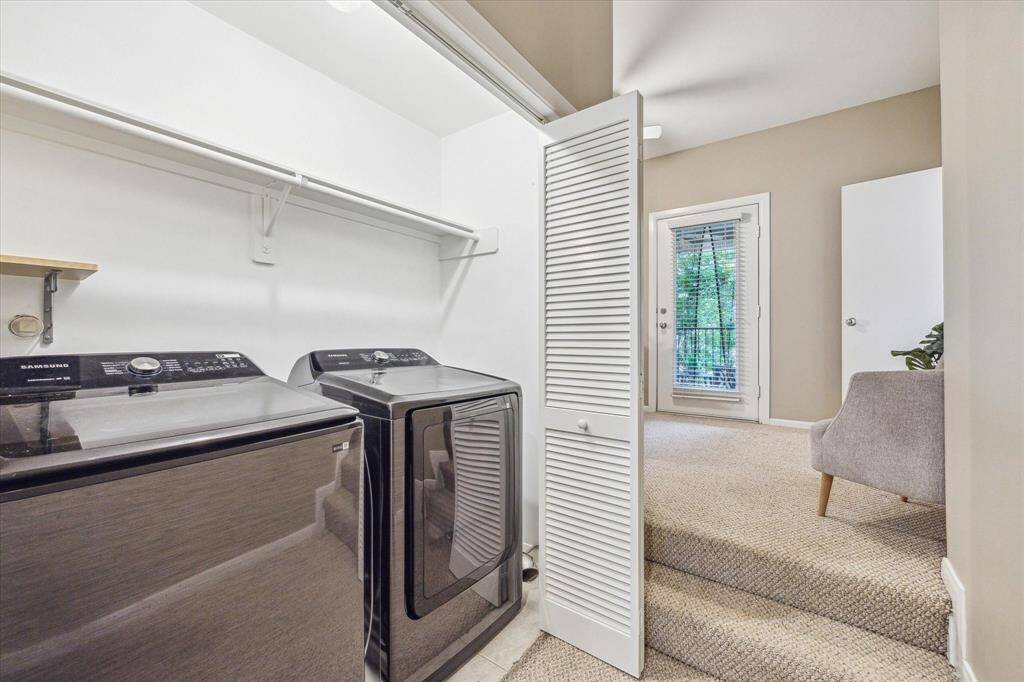 The utility closet is conveniently located on the third floor with the primary suite. It's tucked behind by-fold doors and offers built-in shelving for household storage. As an added bonus, the washer and dryer stay!