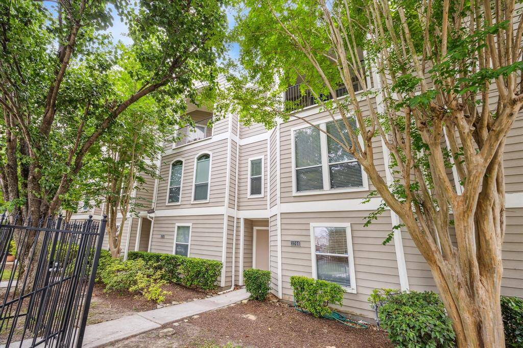 Enjoy the peaceful charm of the gated front yard, complete with a grassy lawn and shaded by towering trees. This inviting outdoor space offers a tranquil welcome and a quiet place to relax just steps from your front door.