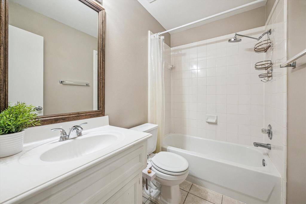 Your guests will appreciate the privacy of this first-floor full bathroom, complete with a single sink vanity, ample storage, and a fully tiled tub/shower enclosure with upgraded fixtures.