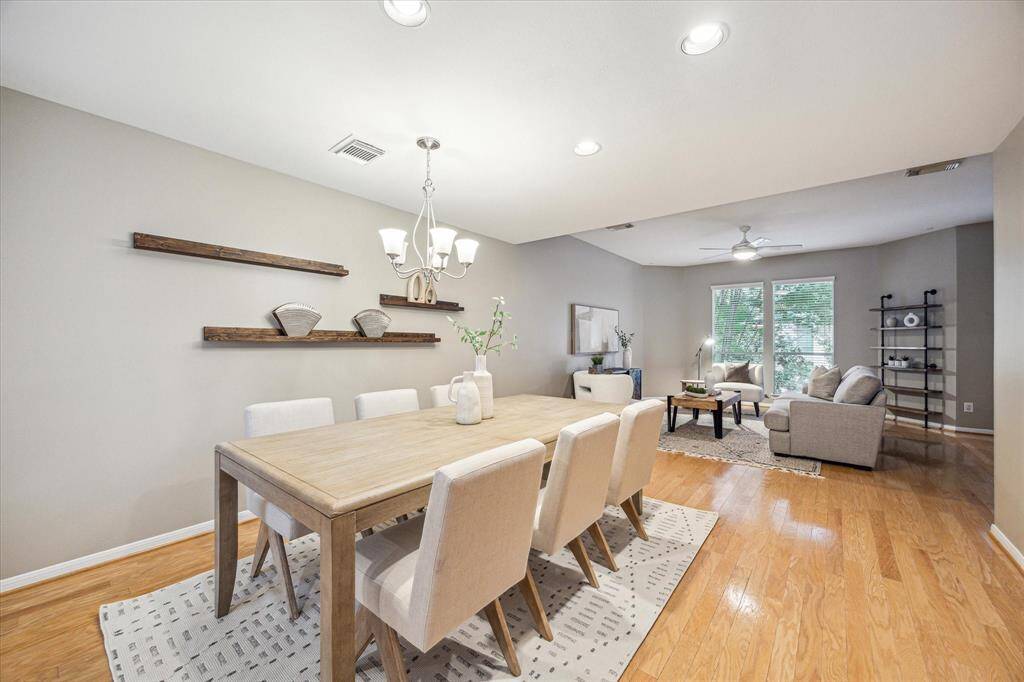 The second-floor living and dining areas offer an open-concept layout with warm wood flooring, soft neutral tones, and recessed lighting. There’s plenty of space to gather, dine, and relax, ideal for both everyday living and effortless entertaining.
