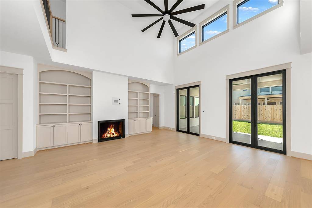 Double metal doors to the back porch with 20 foot ceilings make this room really stand out