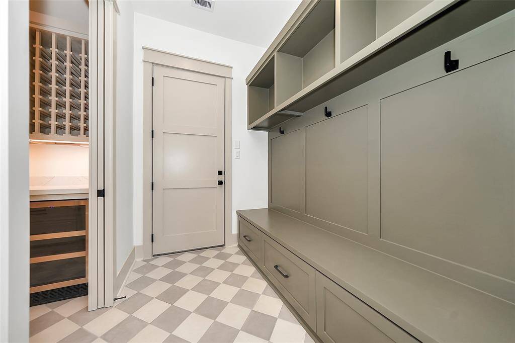 mudroom and oversized pantry with microwave and beverage fridge.