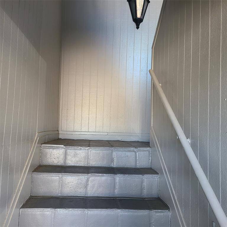 Gray tones & tiled, with a split stairway to entry