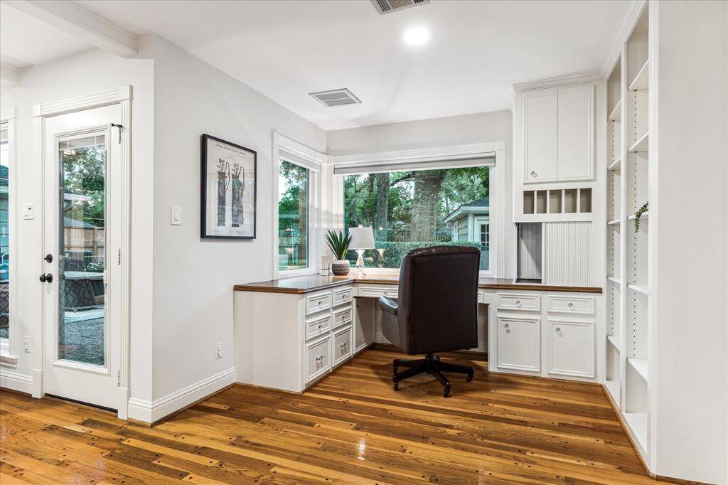 Cozy workspace featuring custom cabinetry and a peaceful view overlooking the backyard—perfect for focused work or study.