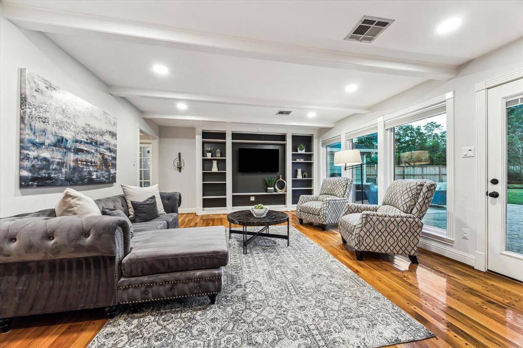 Bright and inviting, this family room boasts a wall of windows overlooking the backyard. Updated recessed lighting with dimmers lets you set the perfect mood.