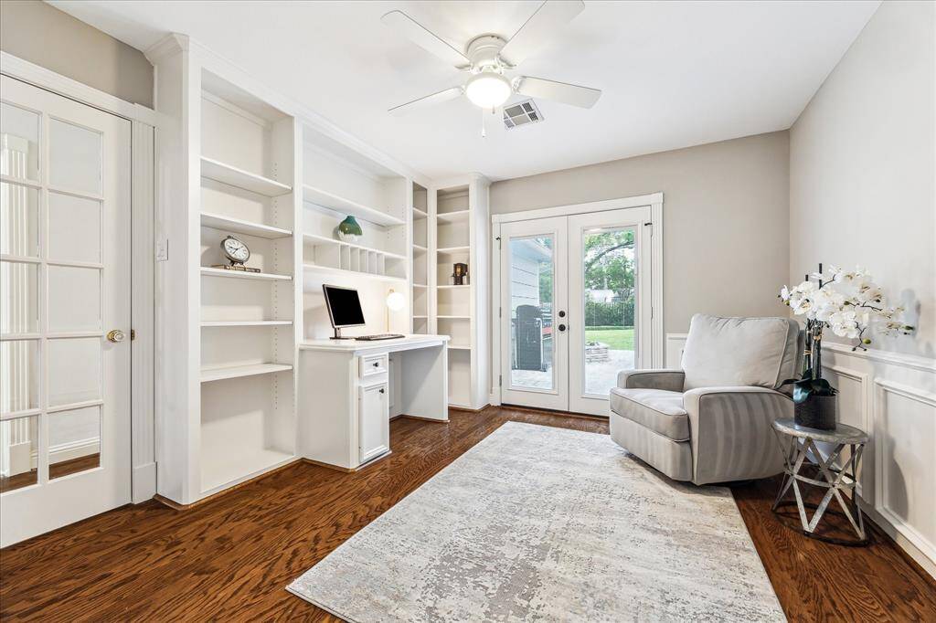 The study offers backyard access, freshly painted built-ins, a built-in desk, and a closet—making it versatile enough to serve as a bedroom.