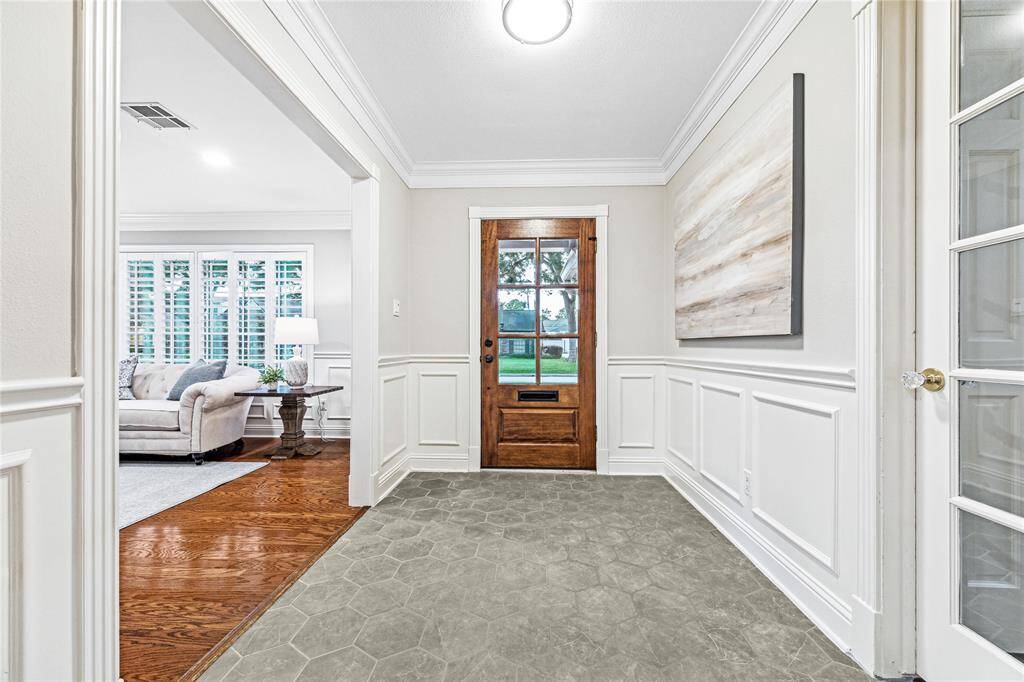 Step into a bright and welcoming entryway featuring recently installed hexagon tile.