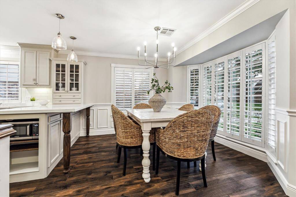 The formal living area flows seamlessly into the dining space and kitchen, creating an open and inviting layout perfect for entertaining.