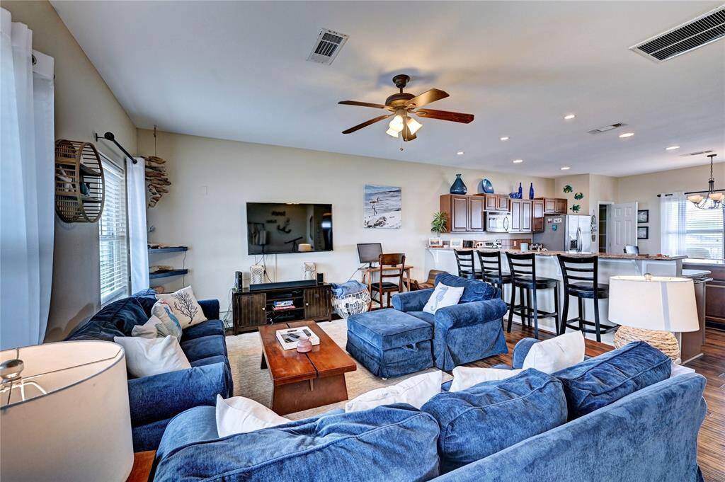 Large living room, with barstools at the breakfast bar assures that as the sun goes down, there is plenty of space for guests to unwind and get cozy.
