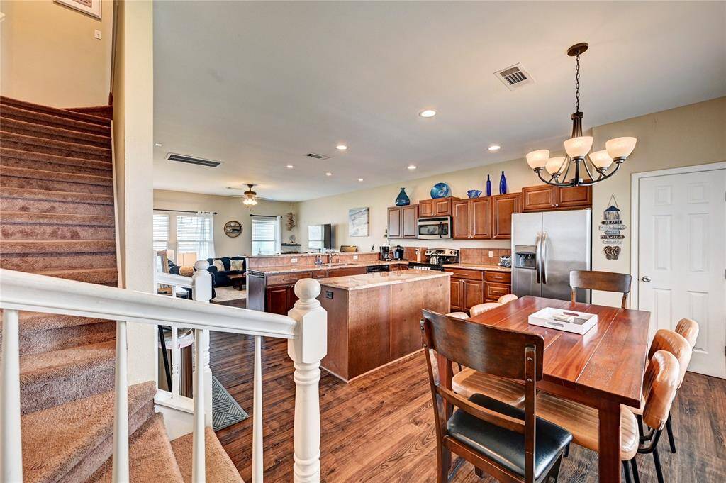 Gorgeous floors catch the eye as you enter the front door and into the dining/kitchen combo.