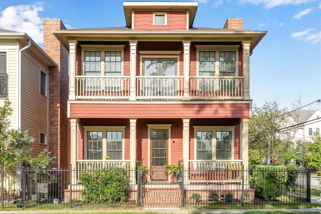 Charming Victorian cottage complete with fenced yard, gracious front porch and relaxing balcony above.