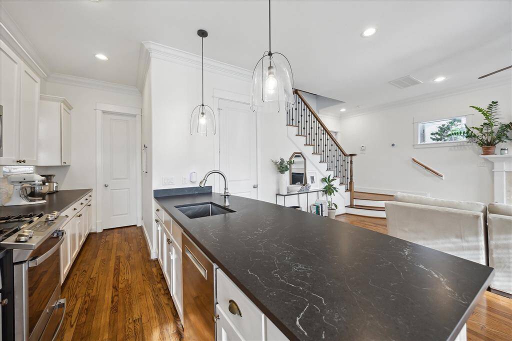 The galley kitchen feels open and spacious. The back door leads to a huge walk-in pantry, offering even more storage space.