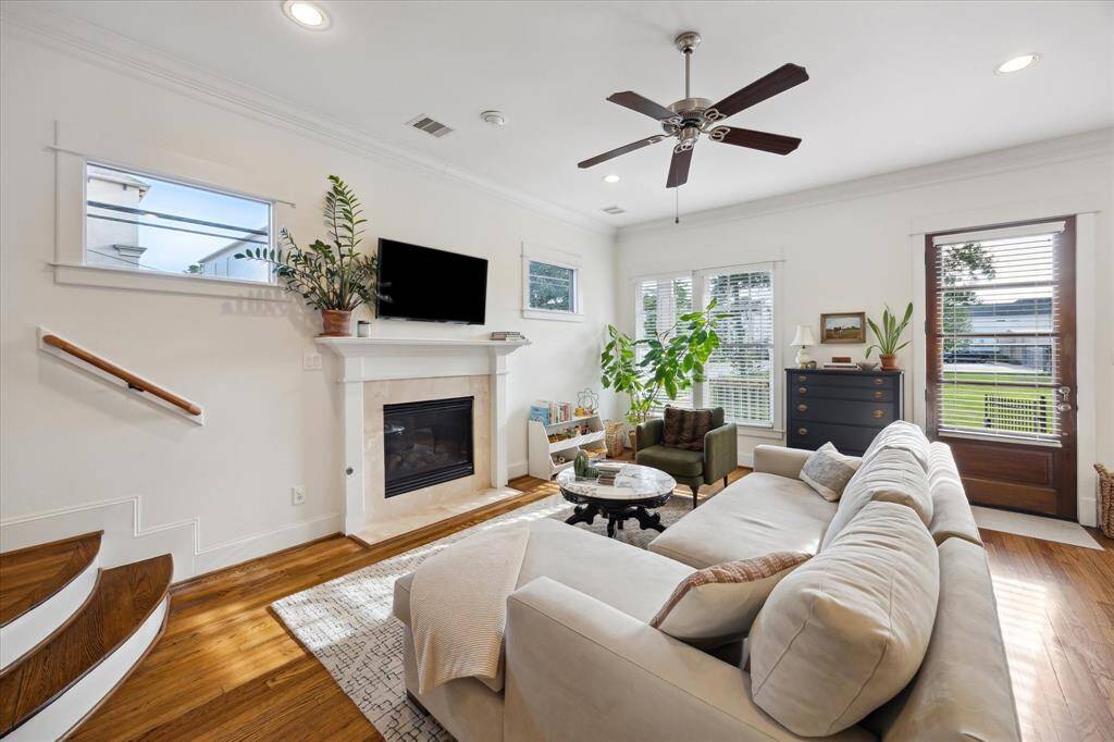 Light and bright the open-concept first floor has a gas fireplace, high ceilings and gleaming hardwood floors.