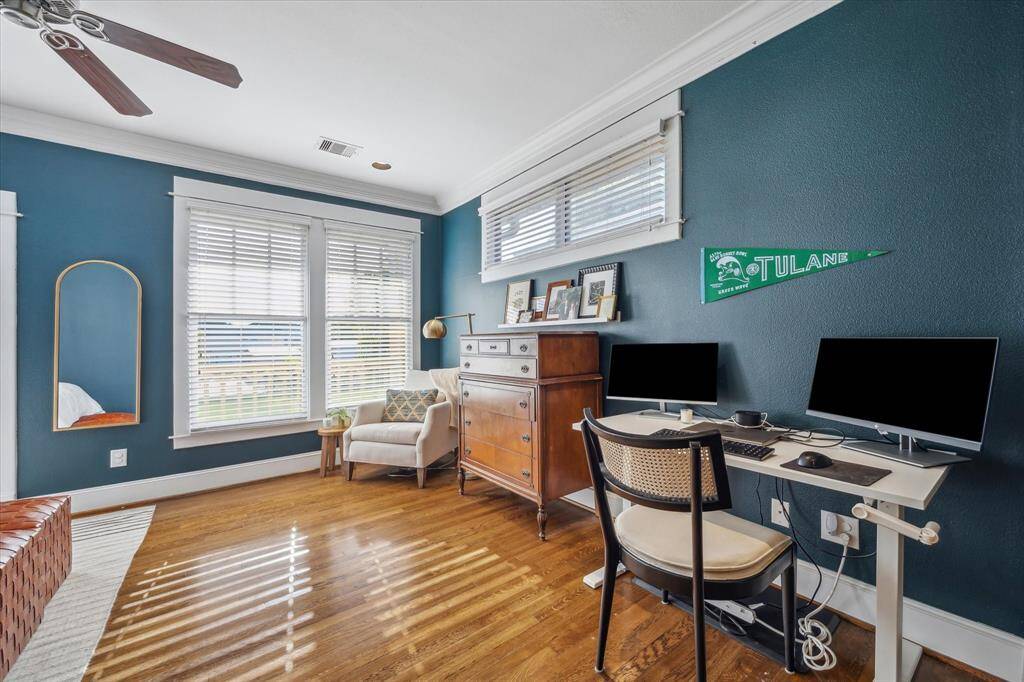 The primary bedroom is large enough for a work space in addition to a comfortable seating area.
