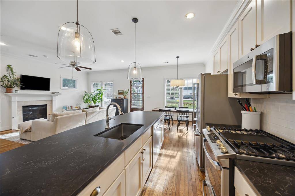 Remodeled in 2024, the kitchen features new appliances, designer pendant lighting, and quartz countertops.