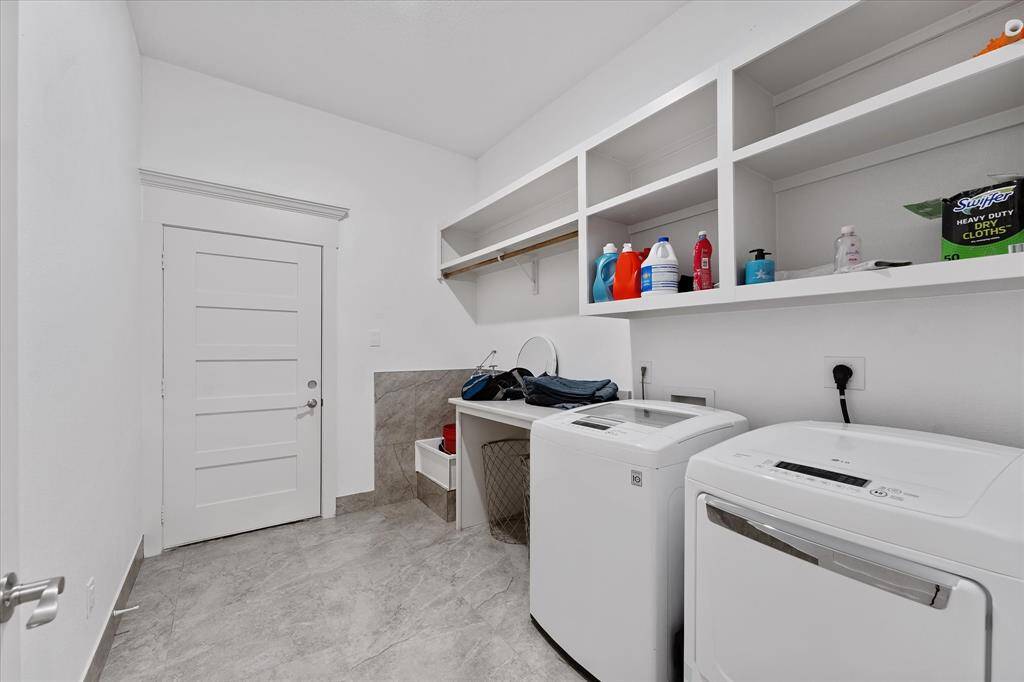 This utility room is centrally located & features a convenient floor mounted commercial-style sink in the corner!