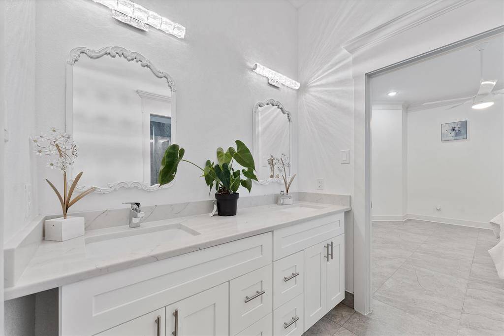 This view of the second Full bathroom highlights the vanity area featuring two separate sinks.