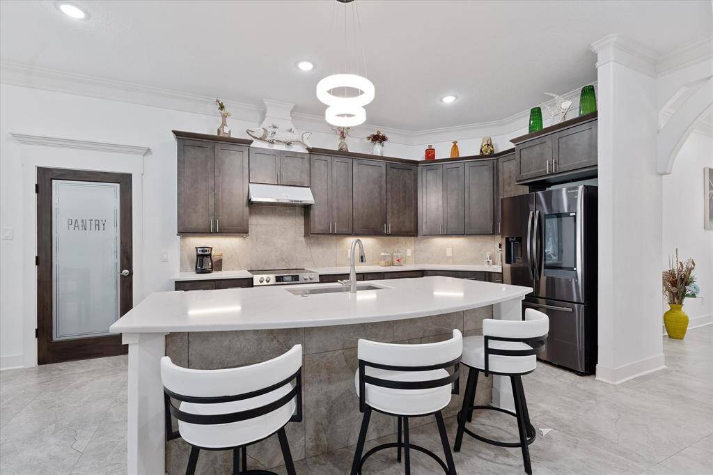 This beautiful island is adorned with matching quartz counter top