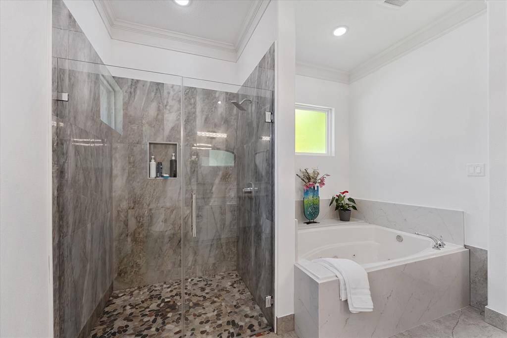 This master bathroom features a separate shower and jetted tub for you to enjoy.