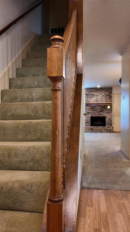 Carpeted steps to second floor