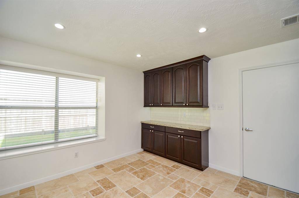 Another view of the breakfast room with wall of cabinets